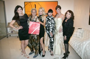 Shari Belafonte (second from left) is happily left holding the Baccarat gift as Laurie Weitz (to the right of Shari) and the “Bond Girls” as spy-themed party benefiting the Palm Springs Art Museum. (Photo by Pat Krause)
